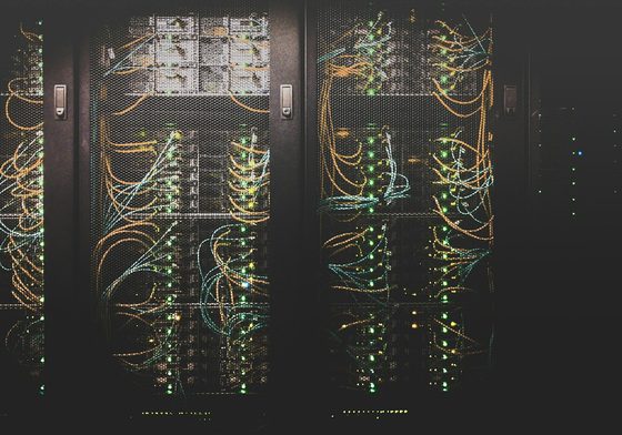 Rows of servers in a data centre, lit by green status LEDs